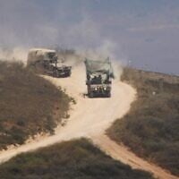 Israeli soldiers drive in southern Lebanon as seen from northern Israel, July 1, 2026. (AP Photo/Ariel Schalit)