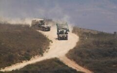 Israeli soldiers drive in southern Lebanon as seen from northern Israel, July 1, 2026. (AP Photo/Ariel Schalit)
