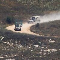 Israeli soldiers drive in southern Lebanon as seen from northern Israel, July 1, 2026. (AP Photo/Ariel Schalit)