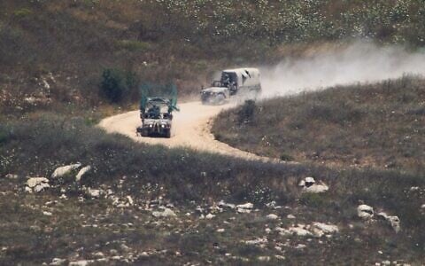 Israeli soldiers drive in southern Lebanon as seen from northern Israel, July 1, 2026. (AP Photo/Ariel Schalit)