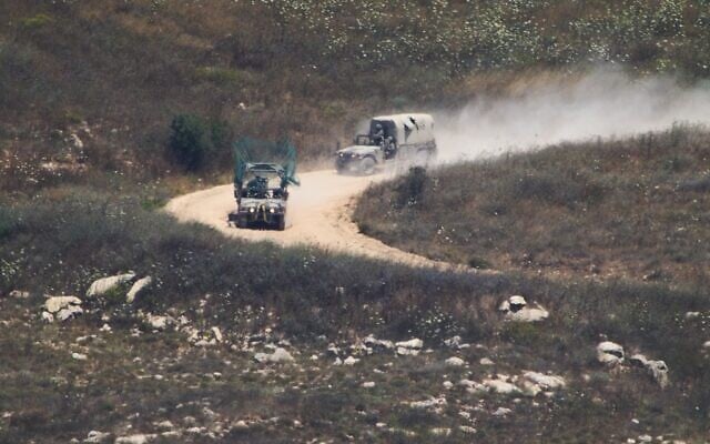 Israeli soldiers drive in southern Lebanon as seen from northern Israel, July 1, 2026. (AP Photo/Ariel Schalit)