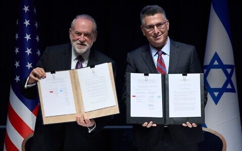 Foreign Minister Gideon Sa'ar (right) and US Ambassador to Israel Mike Huckabee present the land‑allocation agreement for the permanent US Embassy in Jerusalem to the audience during a ceremony on July 1, 2026. (AP/Ohad Zwigenberg)