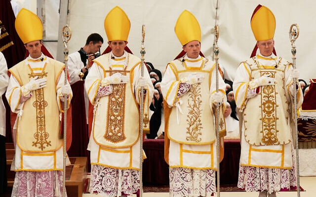 Newly consecrated Bishops, from left, Marc Hanappier, Michel Poinsinet de Sivry, Michael Goldade and Pascal Schreiber wearing their miters and holding their pastoral staffs, stand at the end of their consecration ceremony in a tent set up outside the Society of St. Pius X seminary in Econe, Switzerland, July 1, 2026. (AP Photo/Baz Ratner) Newly consecrated Bishops, from left, Marc Hanappier, Michel Poinsinet de Sivry, Michael Goldade and Pascal Schreiber wearing their miters and holding their pastoral staffs, stand at the end of their consecration ceremony in a tent set up outside the Society of St. Pius X seminary in Econe, Switzerland, July 1, 2026. (AP Photo/Baz Ratner)