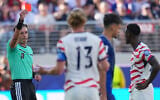 Referee Raphael Claus of Brazil shows a red card to United States' Folarin Balogun, right, during the World Cup round of 32 soccer match between the United States and Bosnia in Santa Clara, California, July 1, 2026. (AP Photo/Julio Cortez)