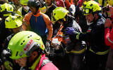 Rescue workers carry Hernán Alberto Gil Flores Gil who was pulled from the rubble eight days after he was trapped by twin earthquakes that struck Catia La Mar, Venezuela, July 2, 2026. (AP Photo/Fernando Vergara)