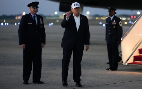 US President Donald Trump gestures after disembarking Air Force One, July 1, 2026, at Joint Base Andrews, Maryland. (AP Photo/Julia Demaree Nikhinson)