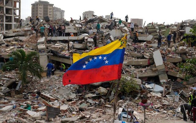 Residents and rescue workers search through the rubble of buildings damaged in the earthquakes that struck La Guaira, Venezuela, July 2, 2026. (AP/Ariana Cubillos)