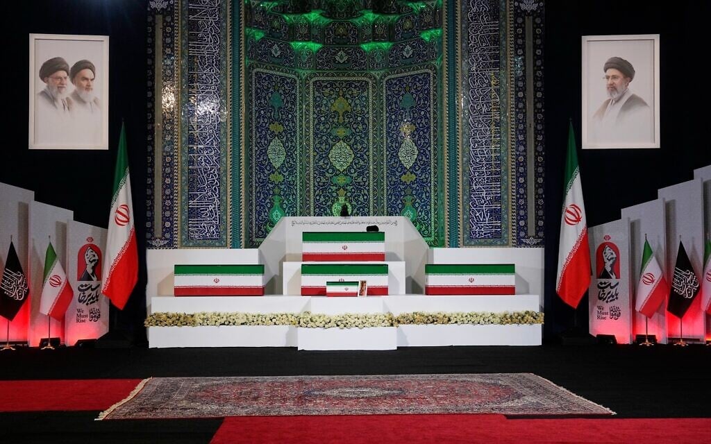 The coffins of slain Iranian Supreme Leader Ayatollah Ali Khamenei, center on top, and members of his family are displayed ahead of the dayslong funeral ceremonies at the Imam Khomeini Mosalla Grand Mosque in Tehran, Iran, July 3, 2026. (AP Photo/Vahid Salemi)