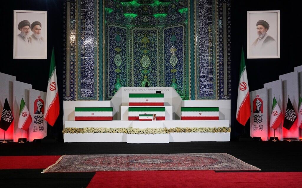 The coffins of slain Iranian supreme leader Ali Khamenei, center top, and members of his family are displayed ahead of the days-long funeral ceremonies at the Imam Khomeini Mosalla Grand Mosque in Tehran, Iran, July 3, 2026. (AP Photo/Vahid Salemi)