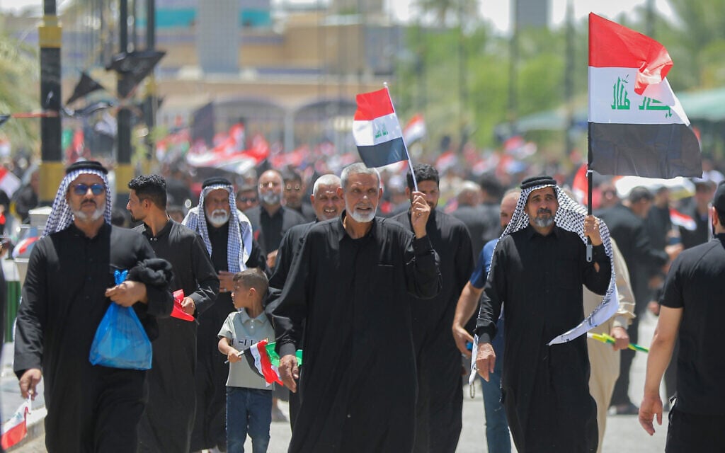 Followers of Iraq's Shiite cleric Muqtada al-Sadr chant slogans as they wave national Iraqi flag during a protest in support of the Iraqi government's anti-corruption measures in Najaf, Iraq, on July 3, 2026. (AP Photo/Anmar Khalil)