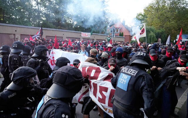 Protesters scuffle with police officers before a party convention of Alternative for Germany, or AfD in Erfurt, Germany, July 4, 2026. (AP Photo/Ebrahim Noroozi)