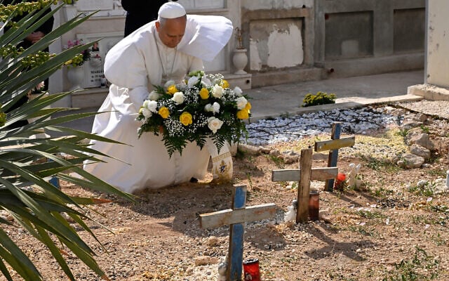 Pope Leo XIV pays tribute at the cemetery and on little Joussef's grave, in Lampedusa, Sicily, southern Italy, July 4, 2026, during a one-day pastoral visit to an island that has become a symbol of the risks faced by migrants trying to reach Europe by sea.(Pool Photo/Ciro Fusco, Via AP)