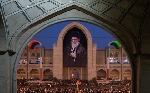 Mourners gather beneath a portrait of the late Iranian Supreme Leader Ayatollah Ali Khamenei during the funeral ceremonies for Khamenei and members of his family at the Imam Khomeini Mosalla Grand Mosque in Tehran, Iran, July 4, 2026. (AP Photo/Altaf Qadri)