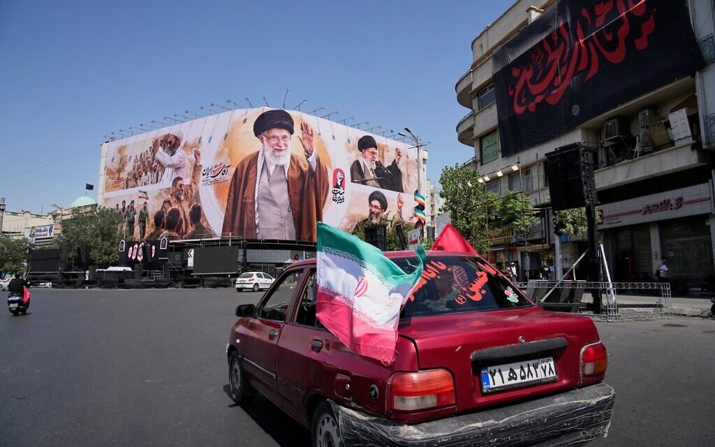 Vehicles drive past a billboard showing the late Iranian Supreme Leader Ayatollah Ali Khamenei in Islamic Revolution Square in Tehran, Iran, July 5, 2026. (AP Photo/Vahid Salemi)