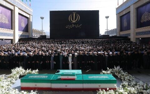 In this photo released by Iran's supreme leader's office, Iran's top officials, including the brothers of Iran's new supreme leader, attend funeral prayers over the coffins of the late ayatollah Ali Khamenei and members of his family at the Imam Khomeini Mosalla Grand Mosque in Tehran, Iran, Sunday, July 5, 2026. (Office of the Iranian Supreme Leader via AP)