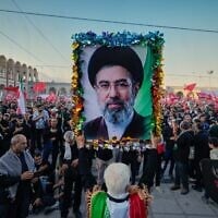 A man holds a picture of Iran's new Supreme Leader Mojtaba Khamenei at the Imam Khomeini Mosalla Grand Mosque, during funeral ceremonies for slain supreme leader ayatollah Ali Khamenei and members of his family in Tehran, Iran, July 5, 2026. (AP Photo/Altaf Qadri)