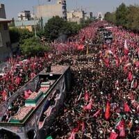 The truck carrying the coffins of the slain Iranian Supreme Leader Ayatollah Ali Khamenei and members of his family makes its way through mourners during the funeral procession toward Azadi Tower in Tehran, Iran, Monday, July 6, 2026. (AP Photo/Vahid Salemi)