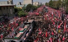 The truck carrying the coffins of the slain Iranian Supreme Leader Ayatollah Ali Khamenei and members of his family makes its way through mourners during the funeral procession toward Azadi Tower in Tehran, Iran, Monday, July 6, 2026. (AP Photo/Vahid Salemi)