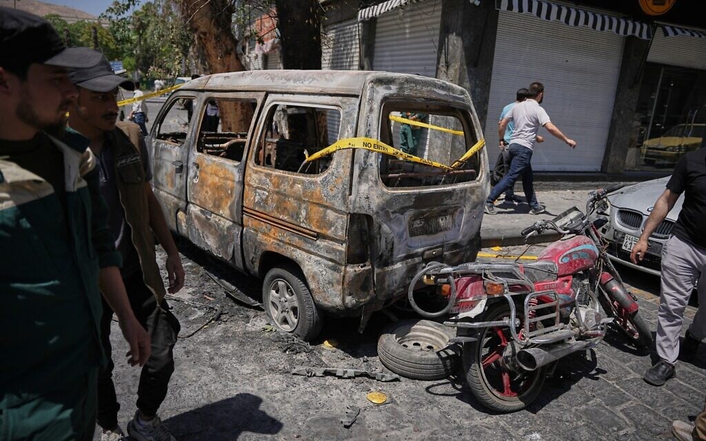 Syrian security personnel inspect a burned vehicles near the Four Seasons Hotel after two explosions rocked the area earlier while Syrian President Ahmad al-Sharaa was meeting French President Emmanuel Macron at the presidential palace, in Damascus, Syria, July 7, 2026. (AP Photo/Omar Albam) Syrian security personnel inspect a burned vehicles near the Four Seasons Hotel after two explosions rocked the area earlier while Syrian President Ahmad al-Sharaa was meeting French President Emmanuel Macron at the presidential palace, in Damascus, Syria, July 7, 2026. (AP Photo/Omar Albam)