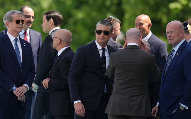 US Defense Secretary Pete Hegseth, center, at the Bestepe Presidential Palace as he waits for a formal welcome for President Donald Trump at the NATO summit in Ankara, Turkey, July 7, 2026. (AP Photo/Francisco Seco)