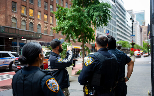 NYPD officers talk about buildings in the area that were evacuated, July 7, 2026, in New York City. (AP/Angelina Katsanis) NYPD officers talk about buildings in the area that were evacuated, July 7, 2026, in New York City. (AP/Angelina Katsanis)
