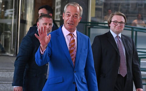 Britain's Reform UK leader Nigel Farage waves as he leaves Milbank Tower in London on July 7, 2026, after announcing he would resign and seek reelection. (AP Photo/Thomas Krych)