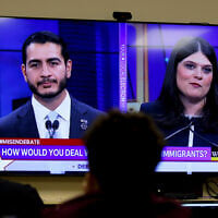 Democratic Michigan US Senate candidates, Abdul El-Sayed, left, and Rep. Haley Stevens are displayed on a television during a debate inside the spin room at WoodTV studios, Grand Rapids, Michigan,  July 7, 2026, (Kristen Norman/AP)