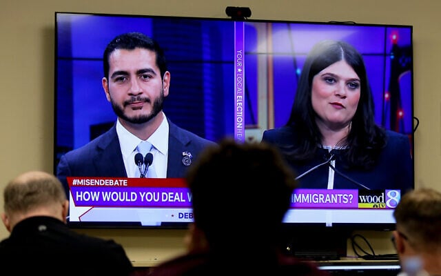 Michigan US Senate candidates, Abdul El-Sayed, left, and Rep. Haley Stevens, D-Mich., are displayed on a television during a debate inside the spin room at WoodTV studios on July 7, 2026, in Grand Rapids, Mich. (AP Photo/Kristen Norman)