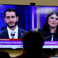 Michigan Democratic US Senate candidates, Abdul El-Sayed, left, and Representative Haley Stevens, are displayed on a television during a debate inside the spin room at WoodTV studios on July 7, 2026, in Grand Rapids, Mich. (AP Photo/Kristen Norman)