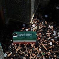 The coffin of the late Iranian supreme leader Ayatollah Ali Khamenei is carried by mourners to the Imam Ali Shrine in Najaf, Iraq, on July 8, 2026. (AP Photo/ Anmar Khalil)