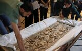 Museum employees unpack a carved stone panel after Syrian authorities unveiled antiquities returned from France at the National Museum in Damascus, Syria, July 8, 2026.(AP/Ghaith Alsayed)