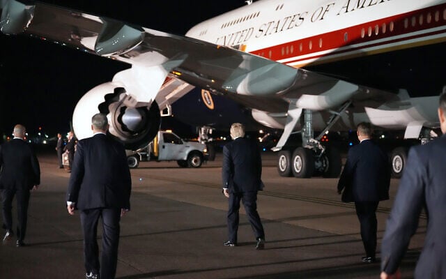 US President Donald Trump, center, switches planes at US Air Force Base, RAF Mildenhall in Suffolk, England, on his way back to Washington from the NATO summit in Ankara, Turkey, July 8, 2026. (AP Photo/Alex Brandon)