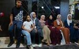 Mais Al-Gharam, second from right, poses for a photo with her six siblings from Gaza, who were granted Israeli passports, in her home in Nazareth, July 8, 2026. (AP Photo/Mahmoud Illean)