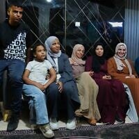 Mais Al-Gharam, second from right, poses for a photo with her six siblings from Gaza, who were granted Israeli passports, in her home in Nazareth, July 8, 2026. (AP Photo/Mahmoud Illean)