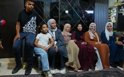 Mais Al-Gharam, second from right, poses for a photo with her six siblings from Gaza, who were granted Israeli passports, in her home in Nazareth, July 8, 2026. (AP Photo/Mahmoud Illean)