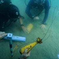 Divers place mock munitions on the floor of the Mediterranean Sea off the coast of Rishon LeZion, Israel, Sunday, June 21, 2026. (AP Photo/Sam Mednick)