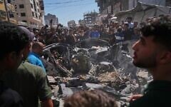 Palestinians gather around a car hit in an Israeli military strike that, according to Hamas-run health authorities, killed at least one person in Gaza City, July 9, 2026. (AP/Jehad Alshrafi)