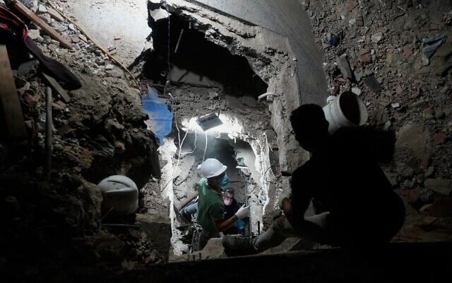 Relatives and rescue workers search through a collapsed building by the earthquakes for their love ones in La Guaira, Venezuela, July 9, 2026. (AP Photo/Ariana Cubillos)
