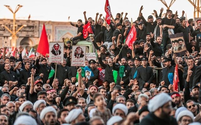In this photo released by Iran's Supreme Leader's office, mourners chant and raise their fists during the final funeral ceremony for the late Iranian Supreme Leader Ayatollah Ali Khamenei at the Imam Reza Shrine before his burial in Mashhad, northeastern Iran, July 9, 2026. (Office of the Iranian Supreme Leader via AP)