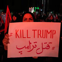 A pro-government demonstrator holds an anti-Trump placard in a gathering commemorating the late Iranian supreme leader ayatollah Ali Khamenei at a square in Tehran, Saturday, July 11, 2026. (AP Photo/Vahid Salemi)