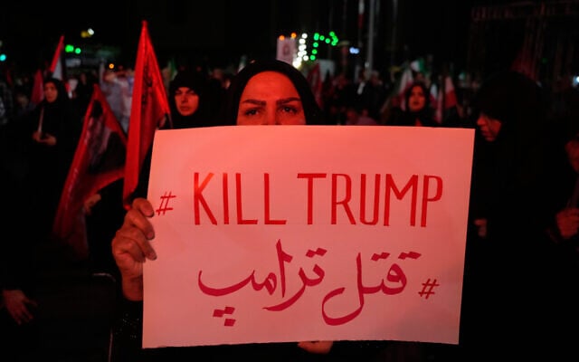 A pro-government demonstrator holds an anti-Trump placard in a gathering commemorating the late Iranian Supreme Leader Ayatollah Ali Khamenei at a square in Tehran, July 11, 2026. (AP Photo/Vahid Salemi)