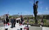 France's President Emmanuel Macron, center right, with Charles Dreyfus, grandson of Alfred Dreyfus, during a tribute ceremony to Captain Alfred Dreyfus, on the Ile de la Cite near the Court of Cassation in Paris, France, July 12, 2026. (Thomas Samson/Pool Photo via AP)