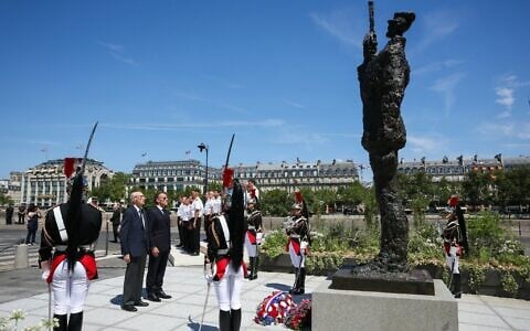 France's President Emmanuel Macron, center right, with Charles Dreyfus, grandson of Alfred Dreyfus, during a tribute ceremony to Captain Alfred Dreyfus, on the Ile de la Cite near the Court of Cassation in Paris, France, July 12, 2026. (Thomas Samson/Pool Photo via AP)