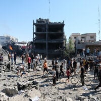 Palestinians gather around the site of an Israeli drone strike in Gaza City’s Sabra neighborhood, July 12, 2026. (AP Photo/ Jehad Alshrafi)