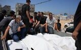 Palestinians carry the bodies of people killed in an Israeli military strike on a residential building on the back of a vehicle as they attend their funeral at Al-Aqsa Hospital in Deir al-Balah, central Gaza Strip, July 15, 2026. (AP/Abdel Kareem Hana)