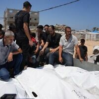 Palestinians carry the bodies of people killed in an Israeli military strike on a residential building on the back of a vehicle as they attend their funeral at Al-Aqsa Hospital in Deir al-Balah, central Gaza Strip, July 15, 2026. (AP/Abdel Kareem Hana)