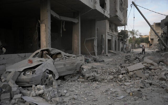 A Palestinian man clears the rubble of destroyed buildings following an Israeli airstrike last night, at al-Maghazi refugee camp, central Gaza Strip, July 16, 2026 (AP Photo/Abdel Kareem Hana)