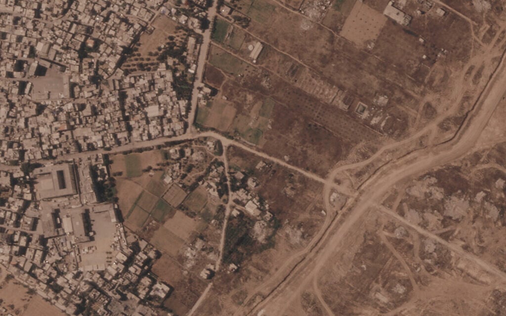 Photos show Israel building miles-long earthen barrier inside area it holds in Gaza