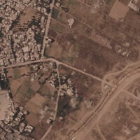 This satellite image from Planet Labs PBC shows a section of an earthen barrier being built by the Israeli military, right side of image moving top to bottom, in the central Gaza Strip, July 1, 2026. At left is the Maghazi camp, and on the other side are homes demolished by the military. (Planet Labs PBC via AP)