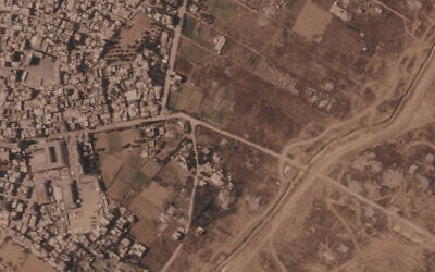 This satellite image from Planet Labs PBC shows a section of an earthen barrier being built by the Israeli military, right side of image moving top to bottom, in the central Gaza Strip, July 1, 2026. At left is the Maghazi camp, and on the other side are homes demolished by the military. (Planet Labs PBC via AP) This satellite image from Planet Labs PBC shows a section of an earthen barrier being built by the Israeli military, right side of image moving top to bottom, in the central Gaza Strip, July 1, 2026. At left is the Maghazi camp, and on the other side are homes demolished by the military. (Planet Labs PBC via AP)
